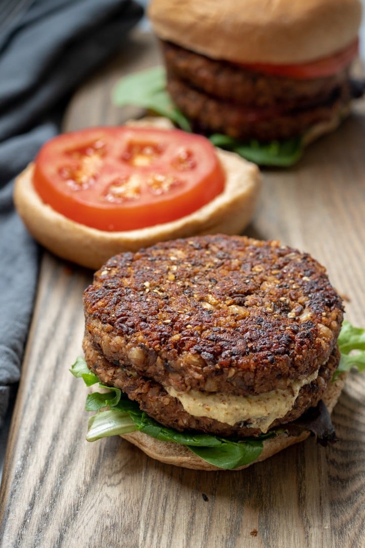 Vegan Mushroom-Barley Burger on a cutting board, with bun and fixings.