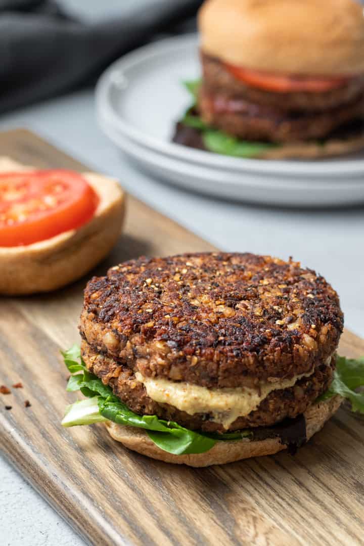 open-face mushroom-barley burger with lettuce and mustard.