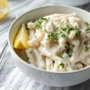 bright photo of vegan lemon pasta in a white bowl.