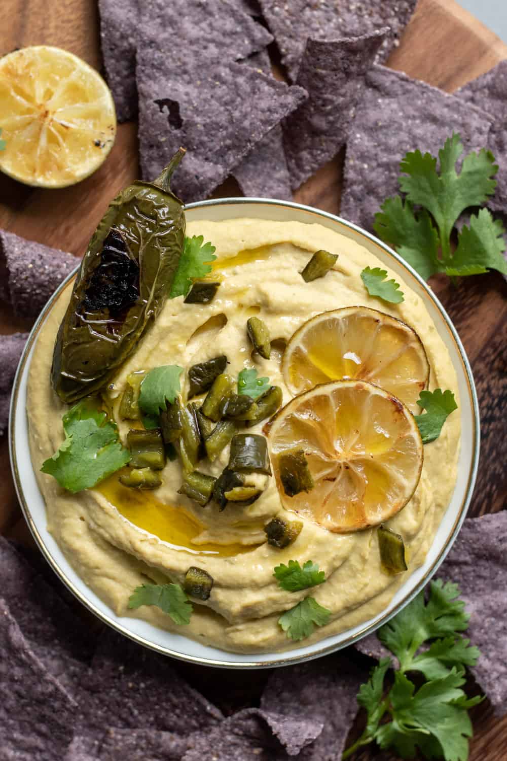 Lime Jalapeno Hummus in a bowl surrounded by tortilla chips