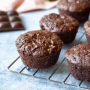 vegan chocolate zucchini muffins on a cooling rack.