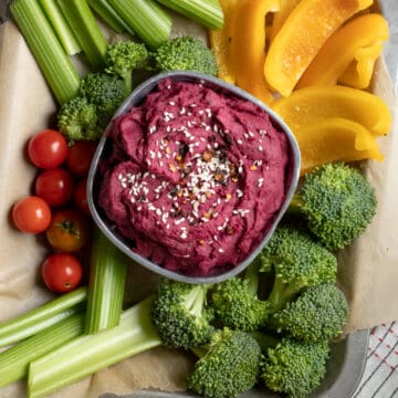 purple sweet potato dip surrounded by raw veggies