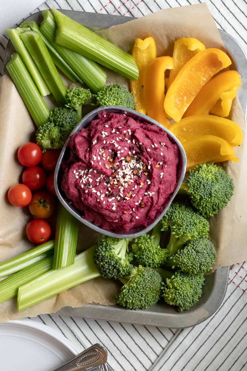 purple sweet potato dip surrounded by raw veggies.