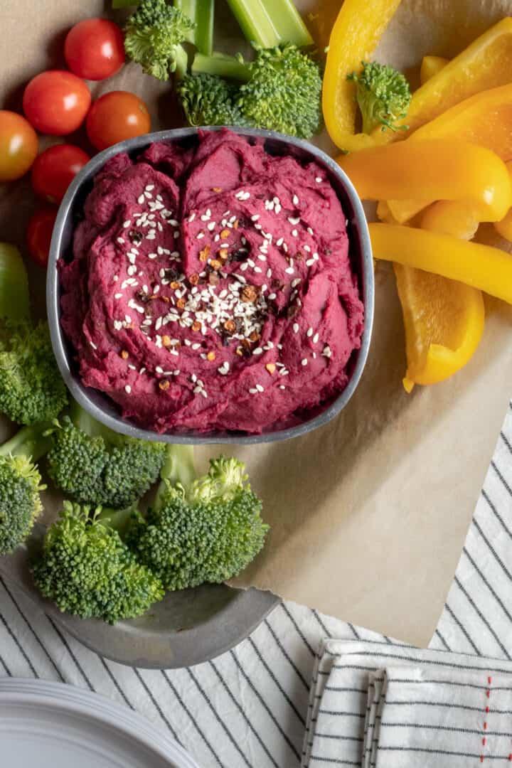 a fresh vegetable tray with chipotle purple potato dip