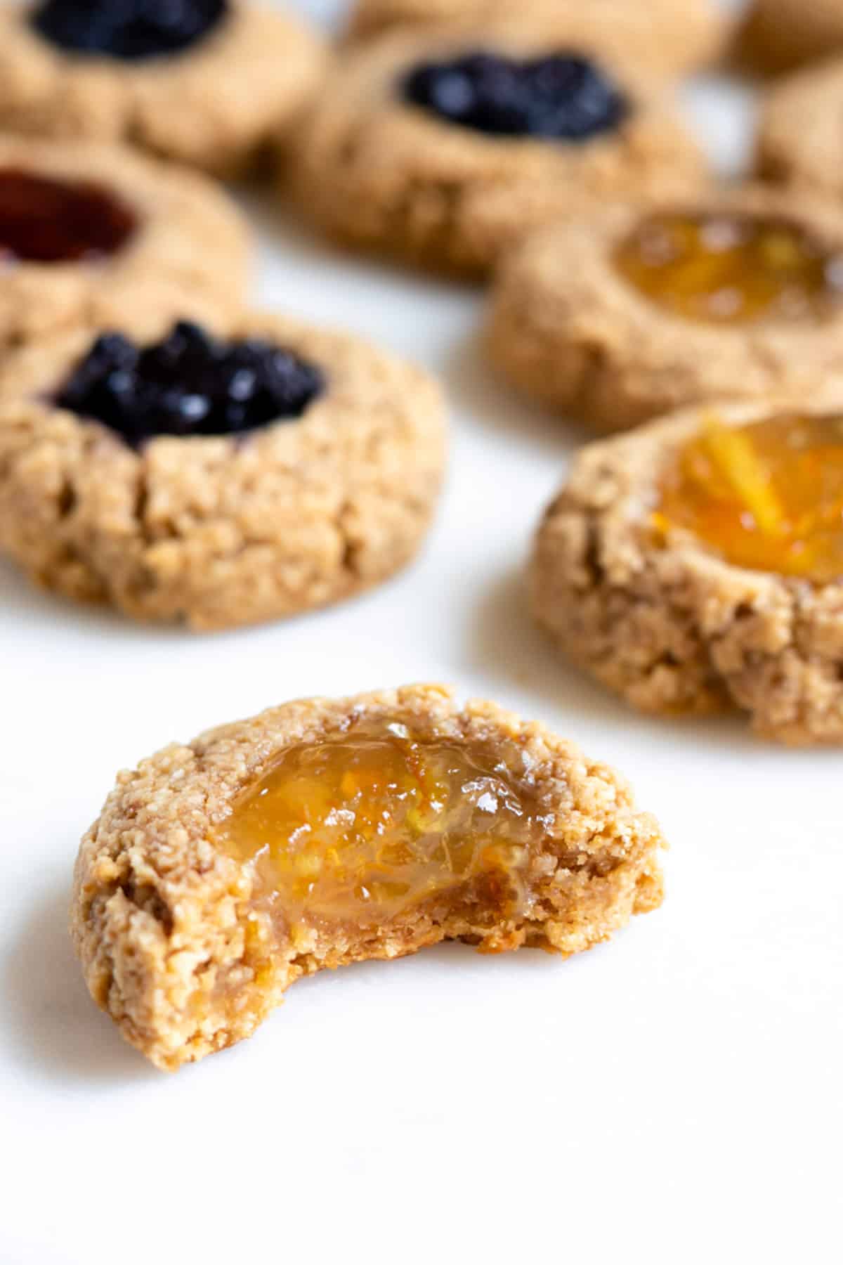 close up of thumbprint cookie with orange jelly