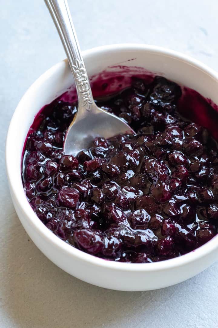 quick homemade blueberry jam in a white bowl.