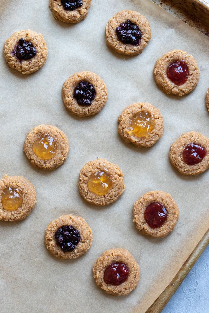thumbprint cookies filled with jelly and ready to be bakes.
