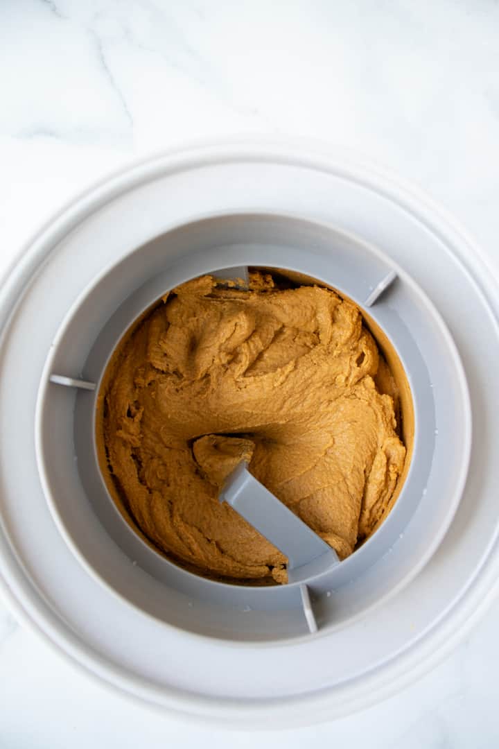 vegan pumpkin ice cream churning in an ice cream maker.