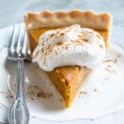 a slice of healthy vegan pumpkin pie dusted with cinnamon.