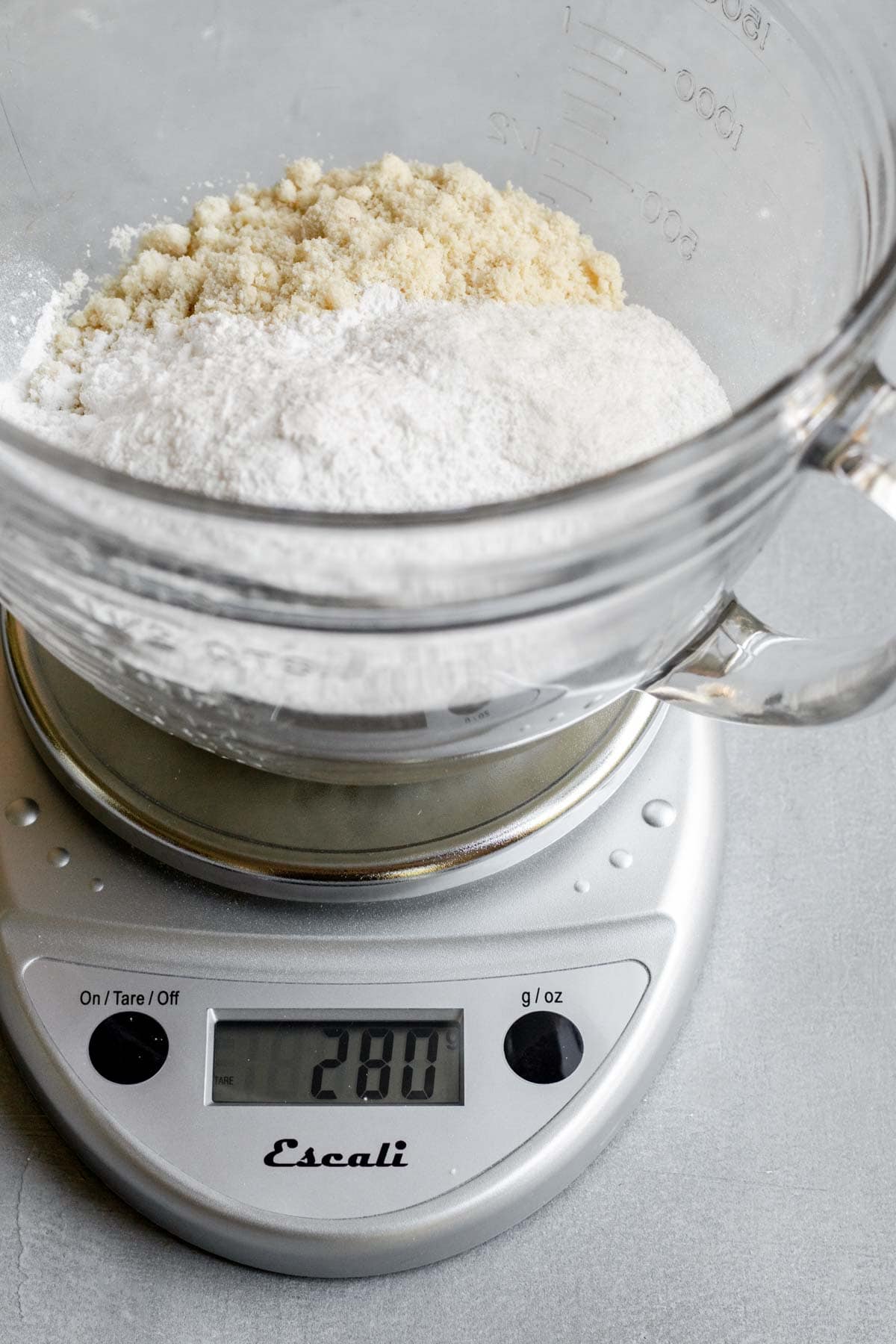 Using a kitchen scale to weigh dry ingredients for pie crust.
