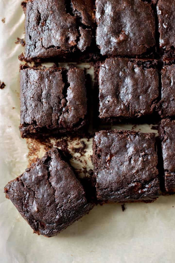 overhead view of dark, low-calorie vegan brownies cut into squares.