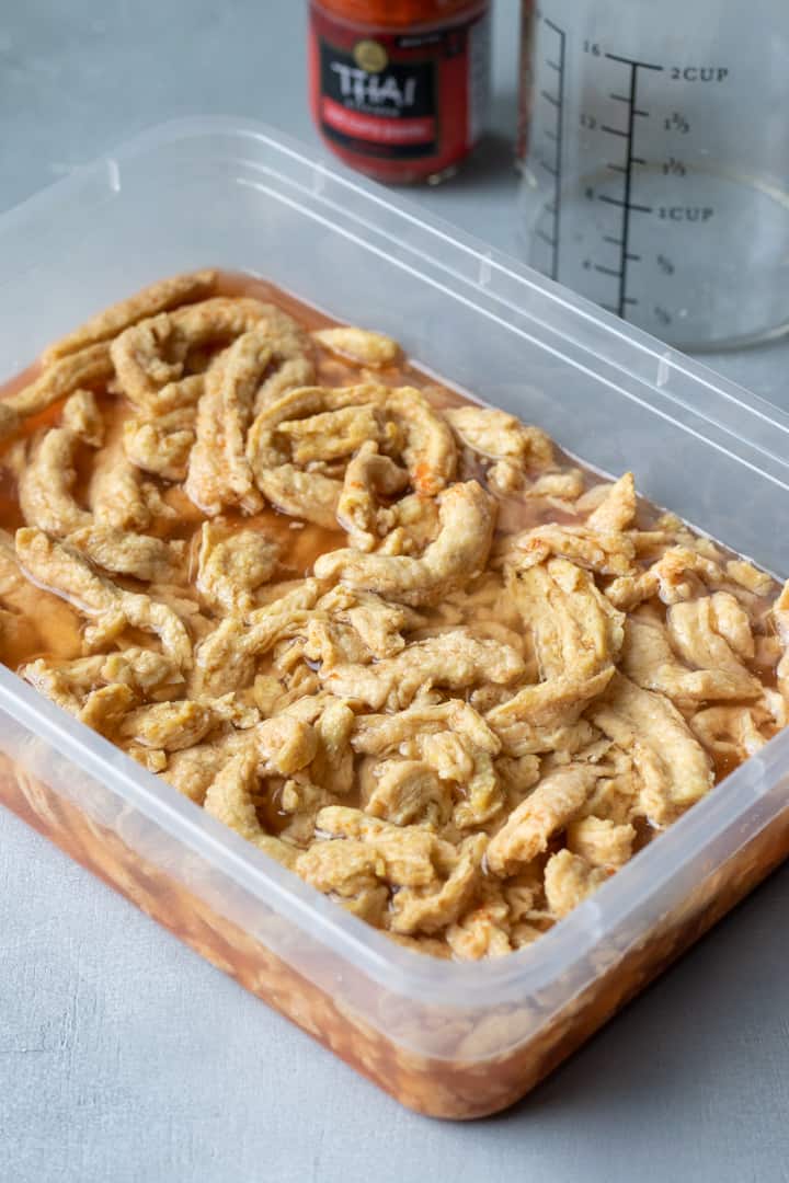 rehydrating soy curls with water and red curry paste.