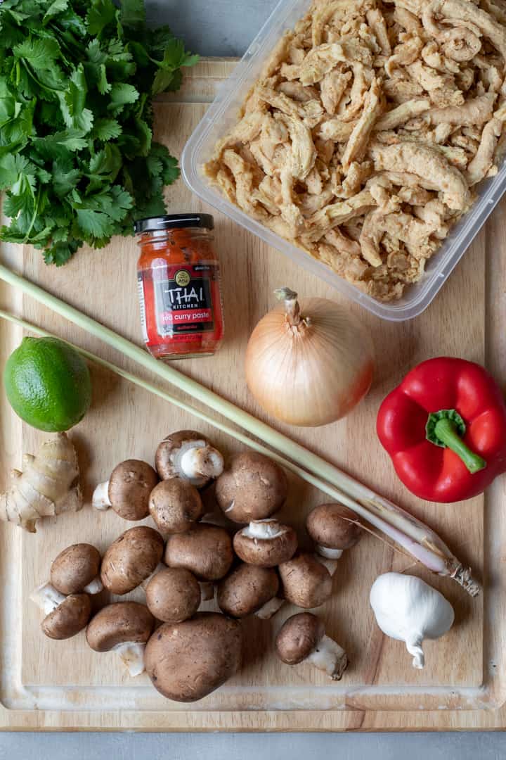 ingredients for Spicy Thai Soup laid out on a cutting board.