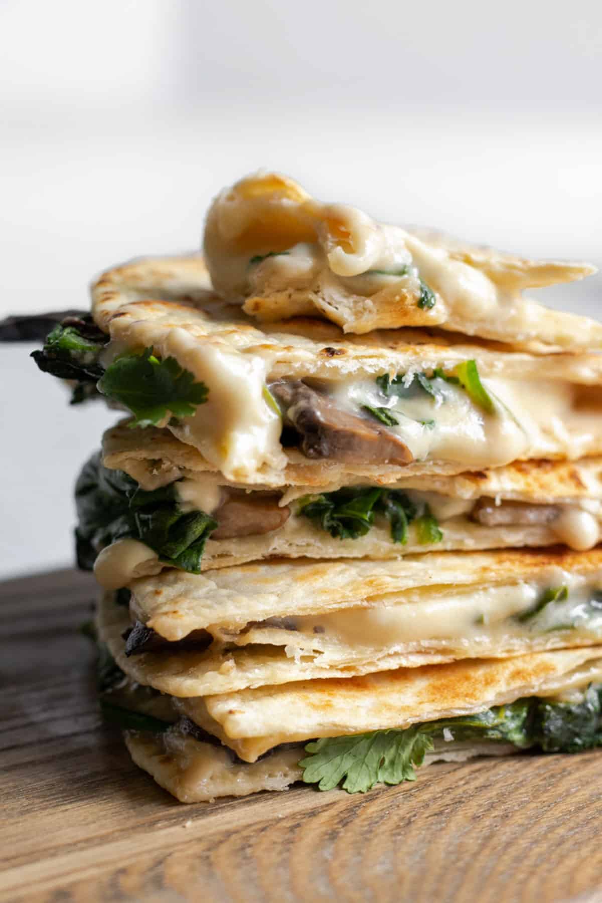 melted cashew cheese, spinach and mushrooms inside vegan quesadillas.