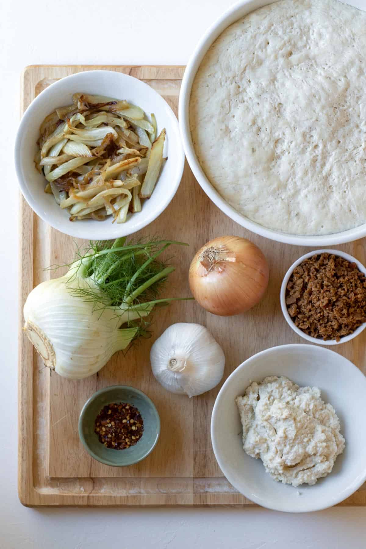 ingredients for fennel, sausage and almond ricotta pizza.