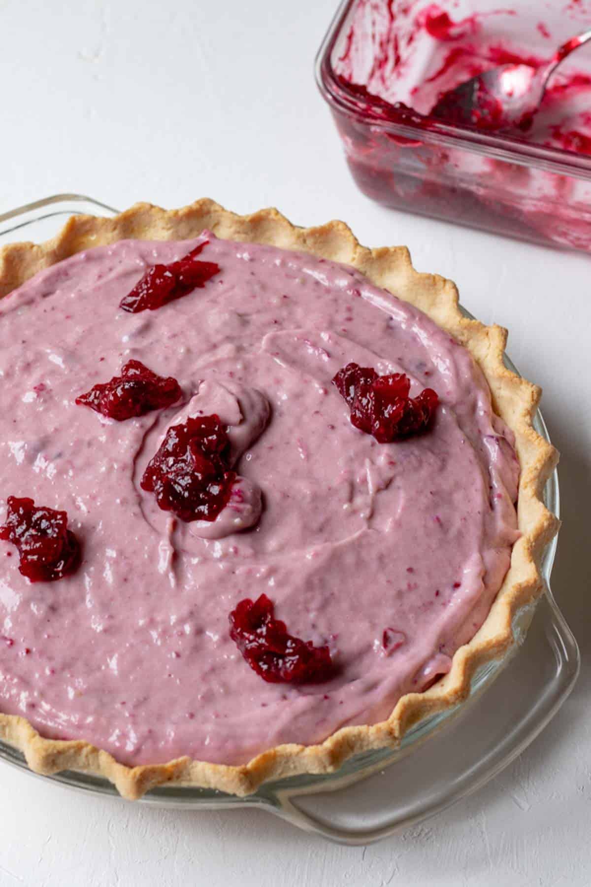 dollops of cranberry sauce on top of pie to create swirl pattern.