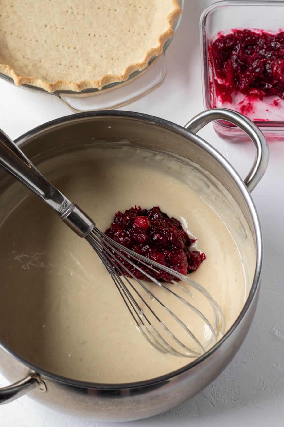 whisking cranberry sauce into the pudding filling.
