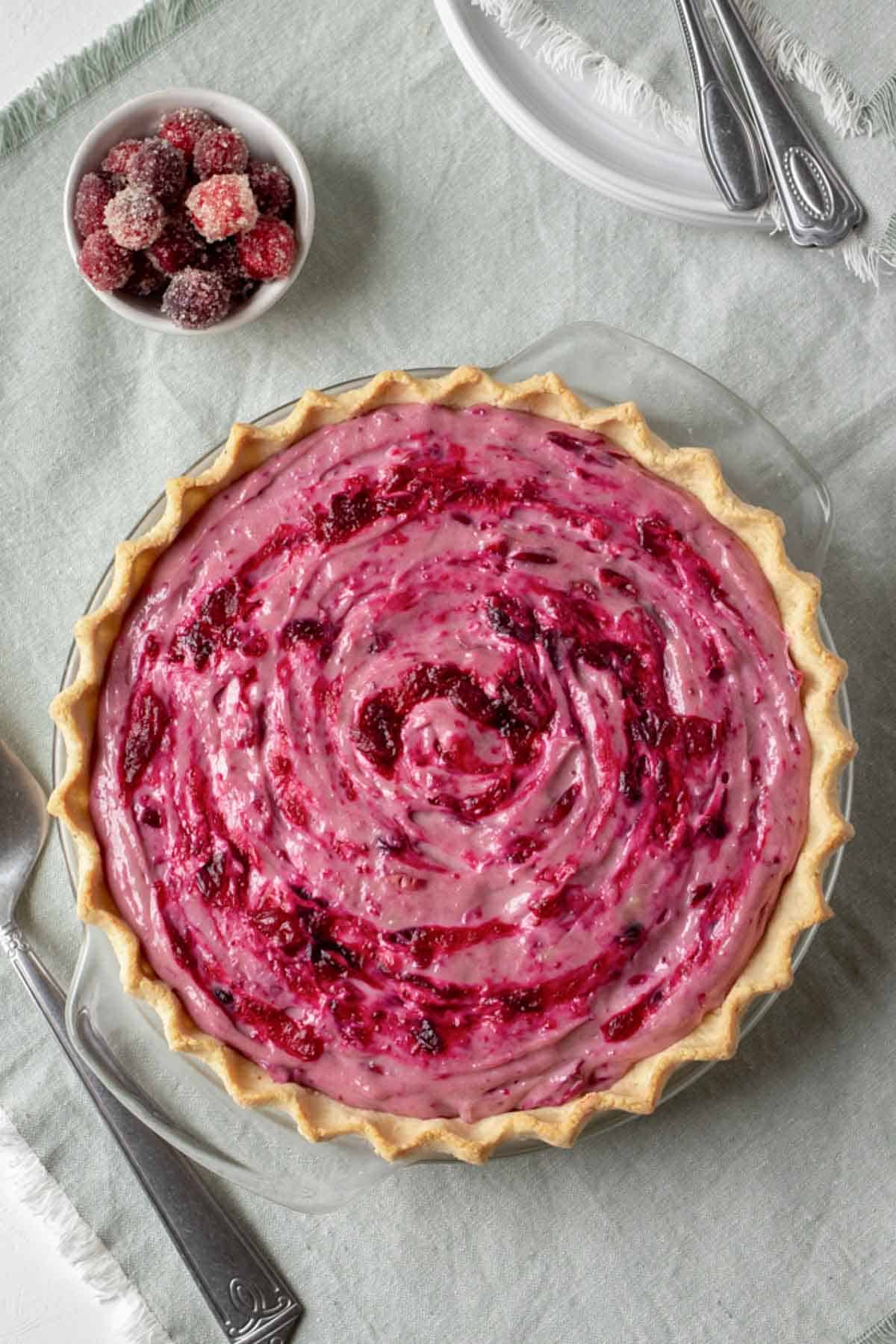 overhead view of vegan cranberry cream pie on a light green napkin.