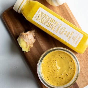 homemade dressing and a bottle of Trader Joe's Almond-Turmeric Dressing