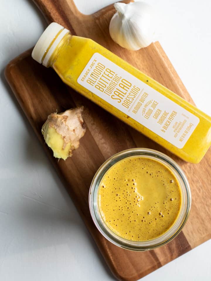 homemade dressing and a bottle of Trader Joe's Almond-Turmeric Dressing