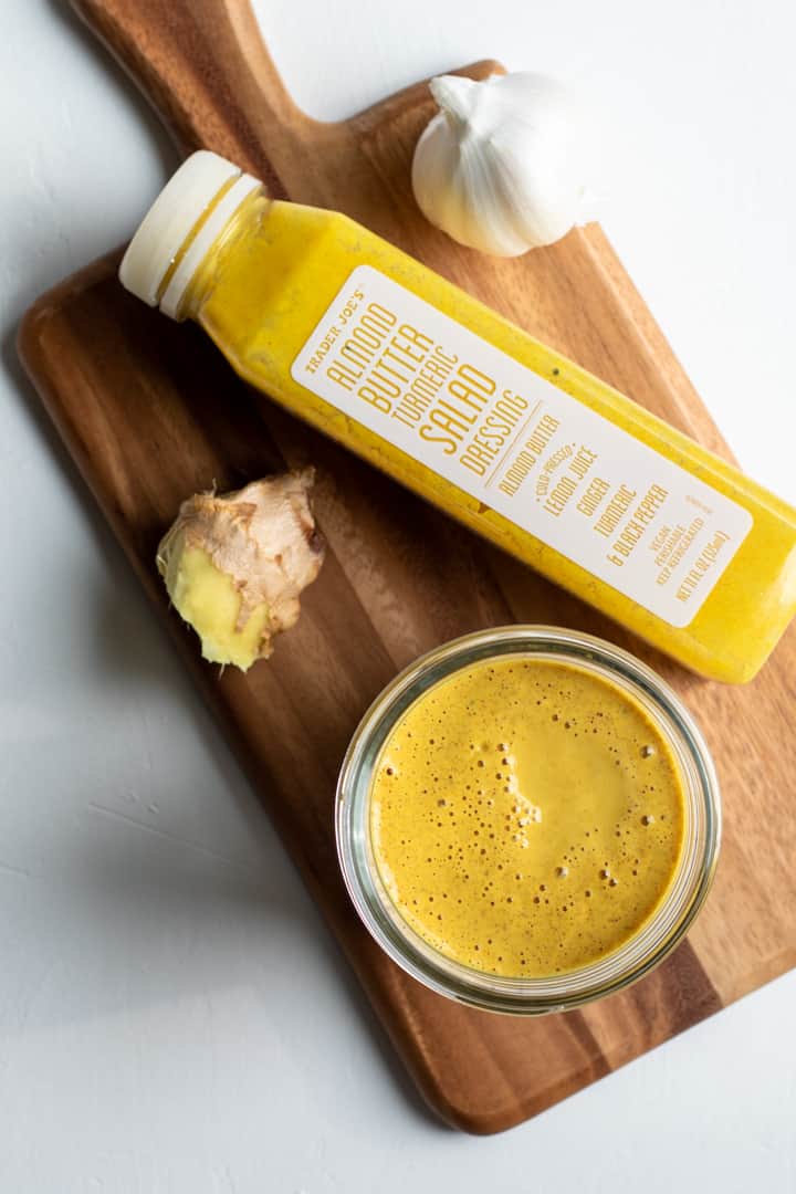 homemade dressing and a bottle of Trader Joe's Almond-Turmeric Dressing.