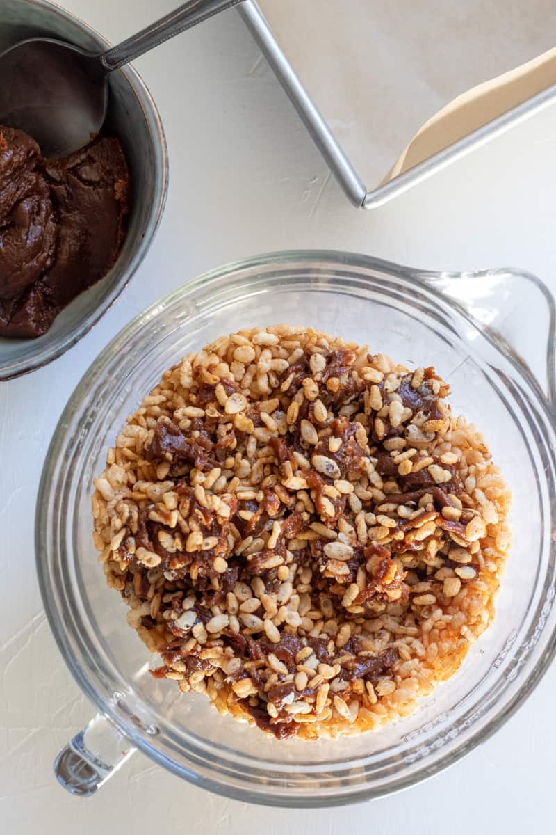 stirring date paste into crispy rice cereal.