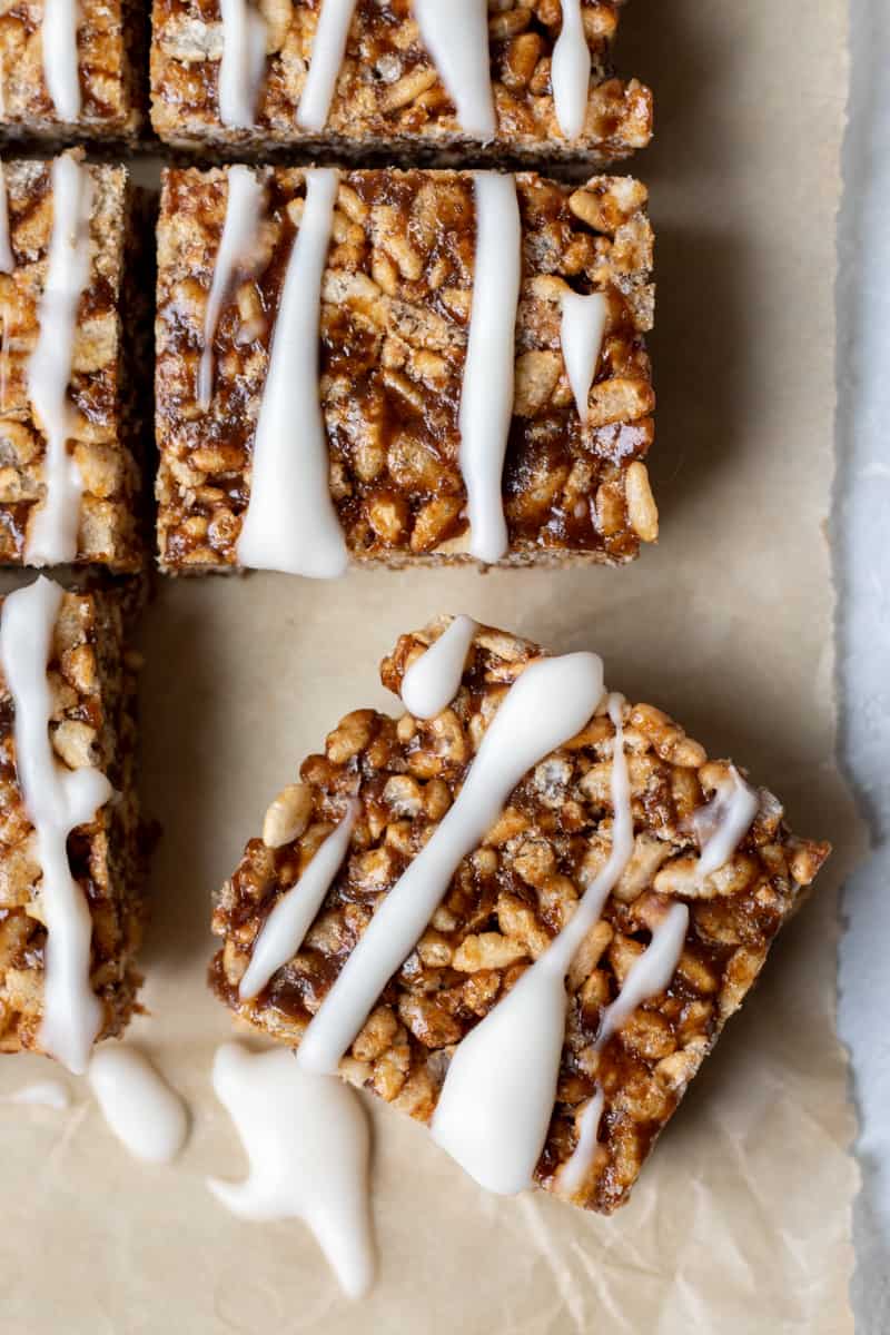 close up of vegan date-sweetened rice krispie treat drizzled with coconut butter glaze.