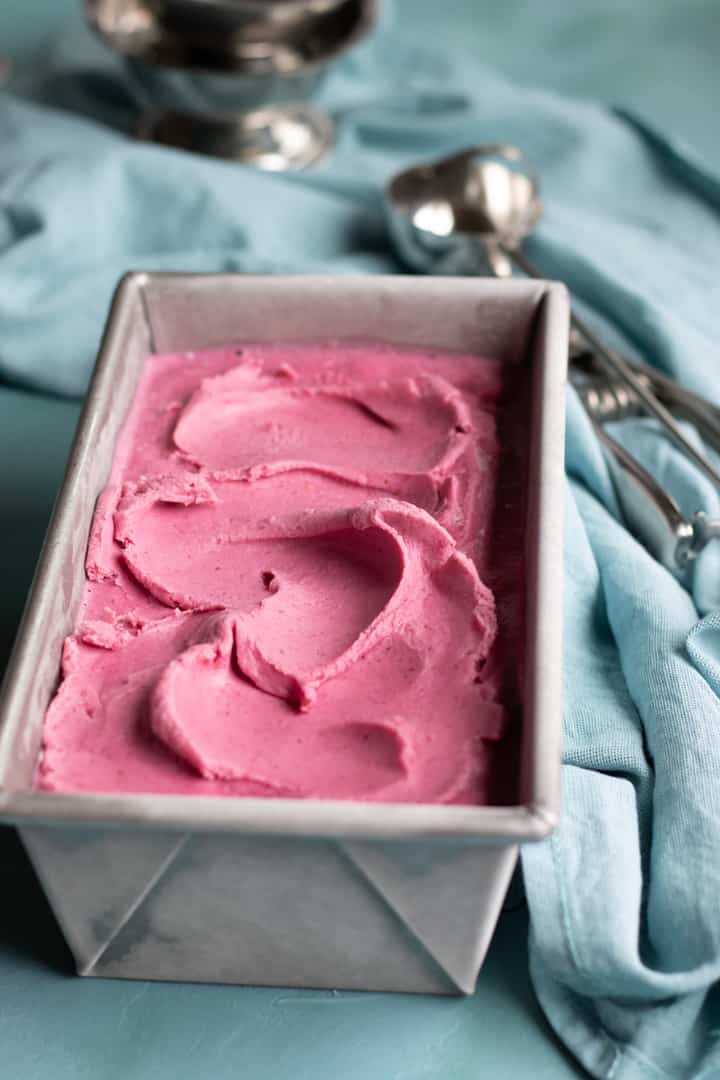 beautifully pink cranberry gelato frozen in metal loaf pan.