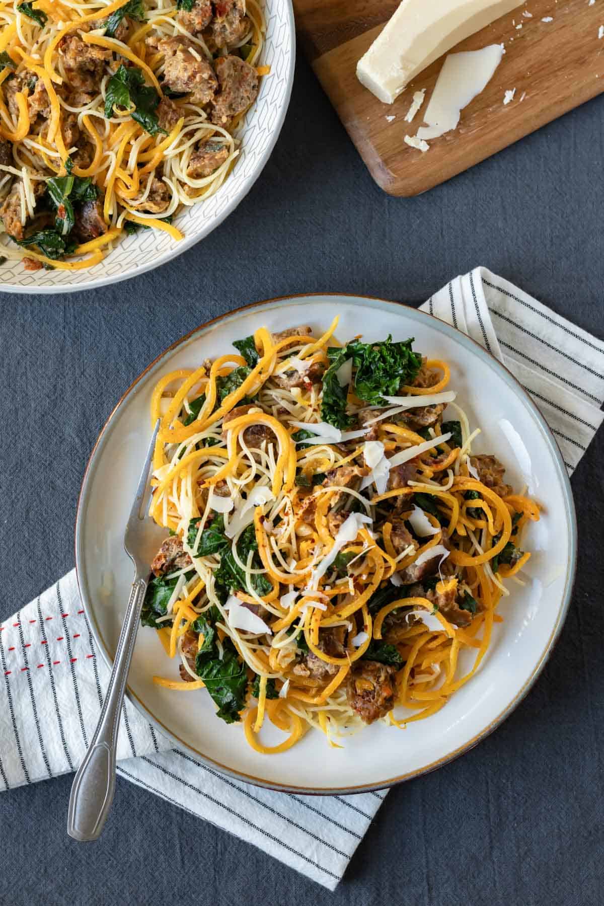 Spiralized butternut squash noodles with angel hair and vegetables on a plate.