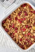 apple cranberry baked oatmeal in a white square baking dish