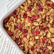 apple cranberry baked oatmeal in a white square baking dish