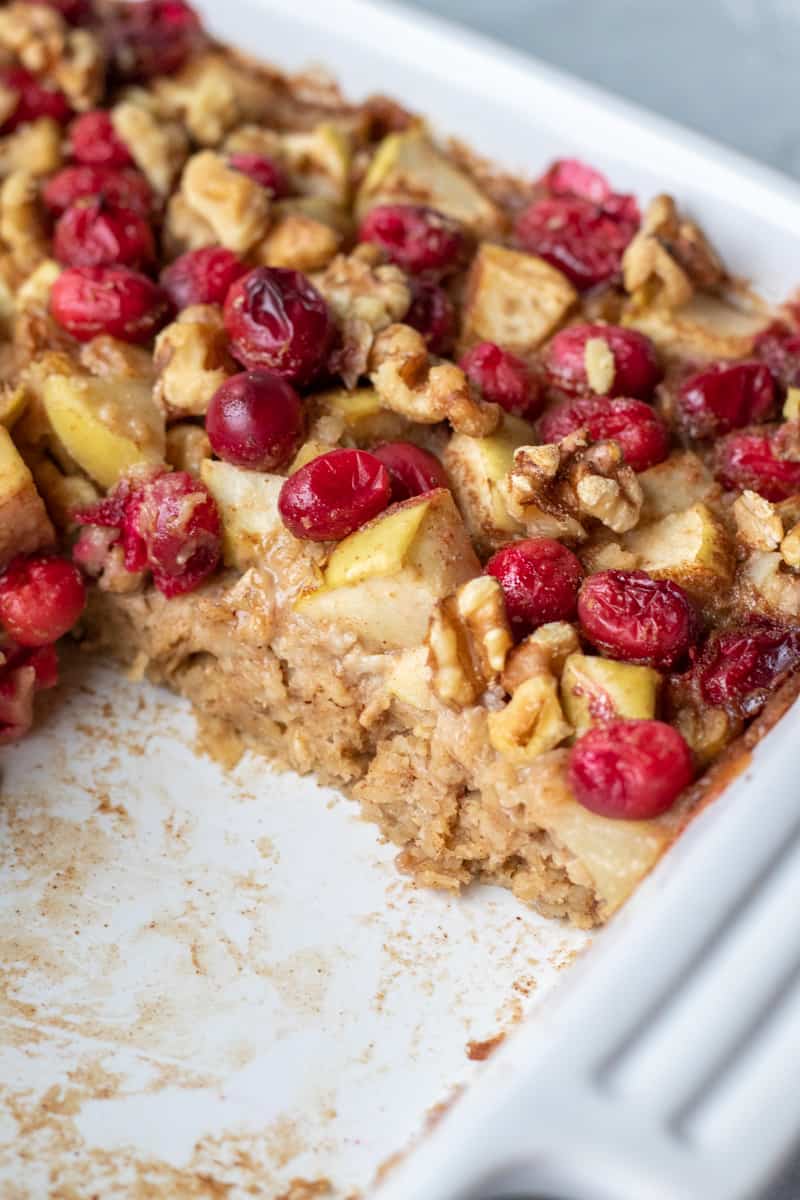 cross-section of apple cranberry baked oatmeal in a pan.
