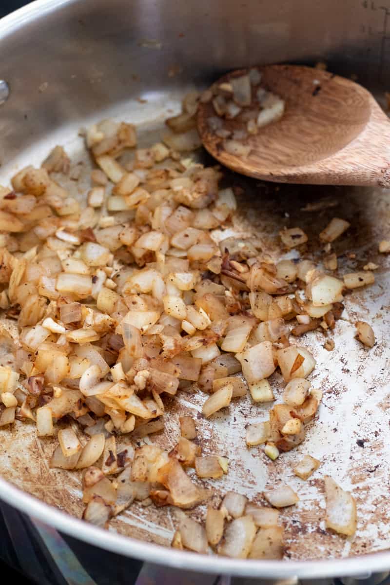 sautéing onion and garlic in a pan .