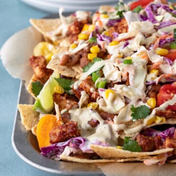 vegan bbq nachos piled on a serving tray