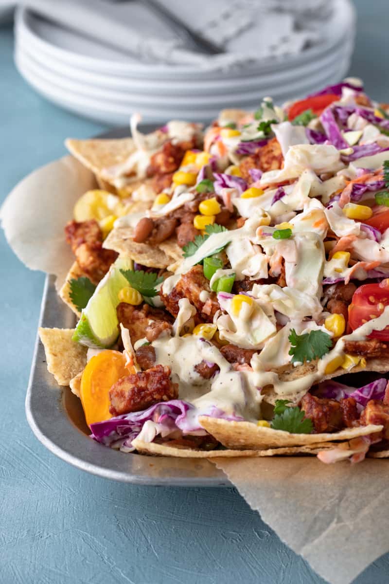 vegan bbq nachos piled on a serving tray.