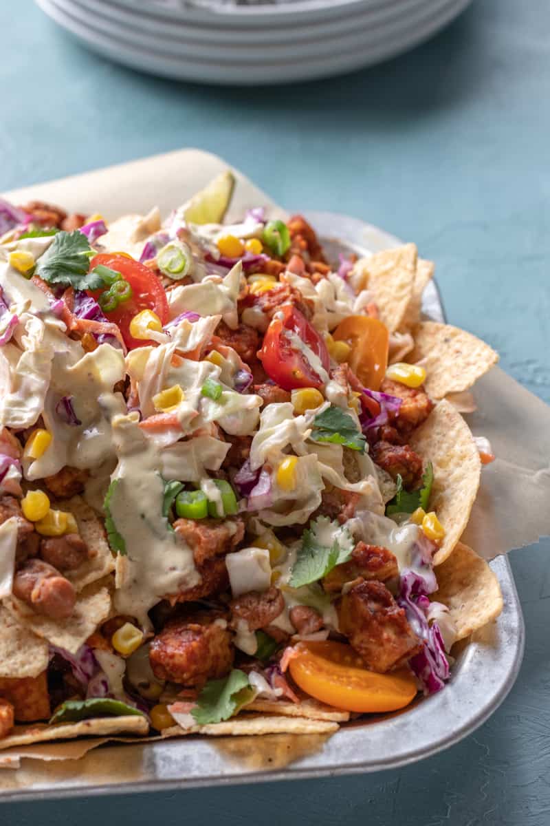 loaded vegan nachos with bbq tempeh, coleslaw, and more.