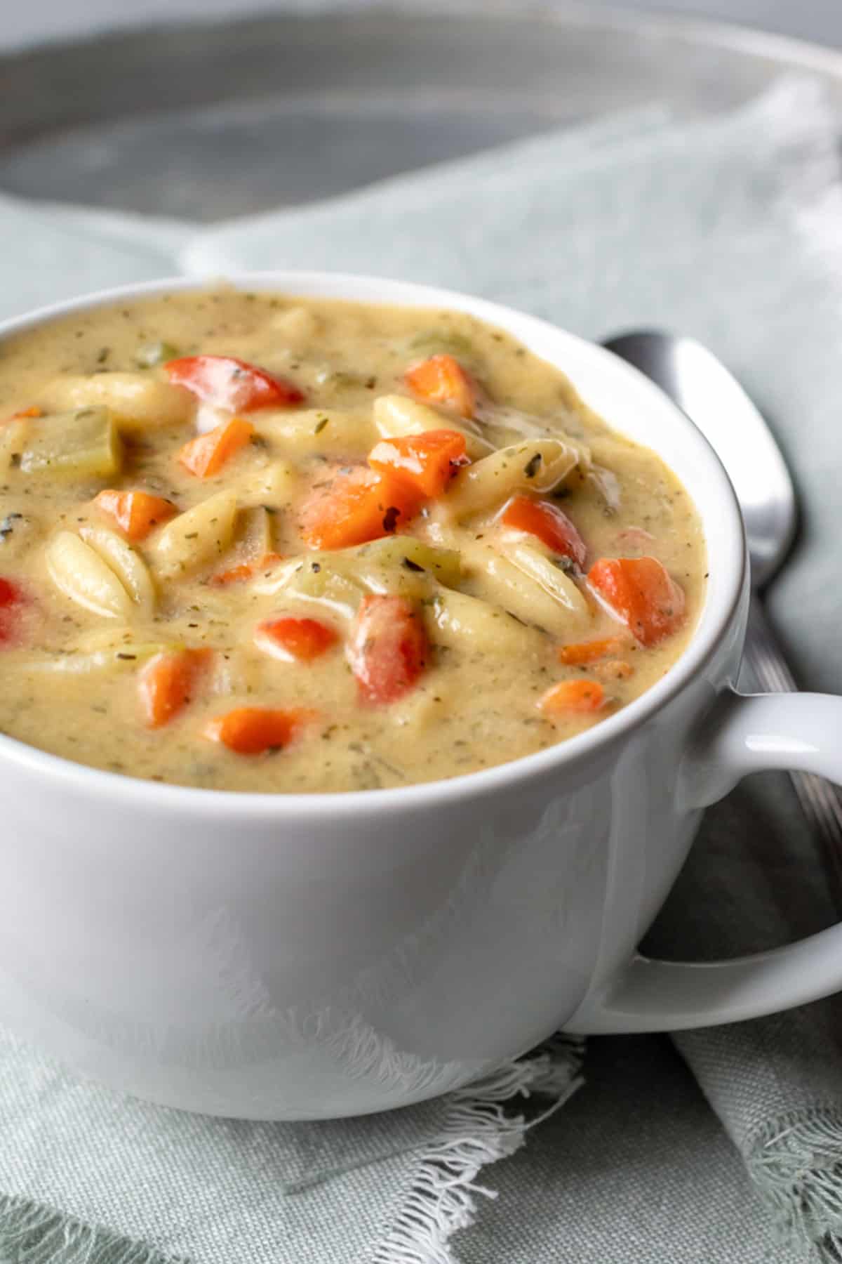 close up of creamy vegetable soup in a mug.