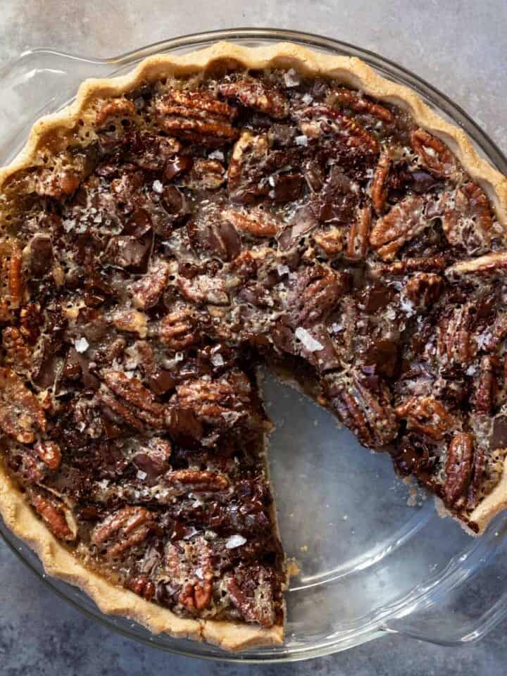 overhead view of chocolate pecan pie with one slice removed.