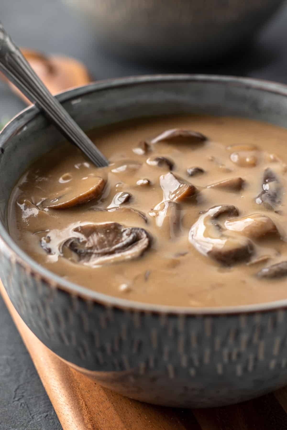 close up of soup in a blue bowl showing the creamy consistency.