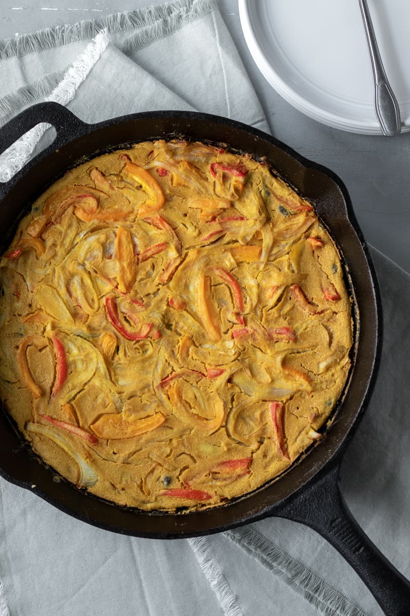 hash brown-crusted frittata in a cast iron pan.