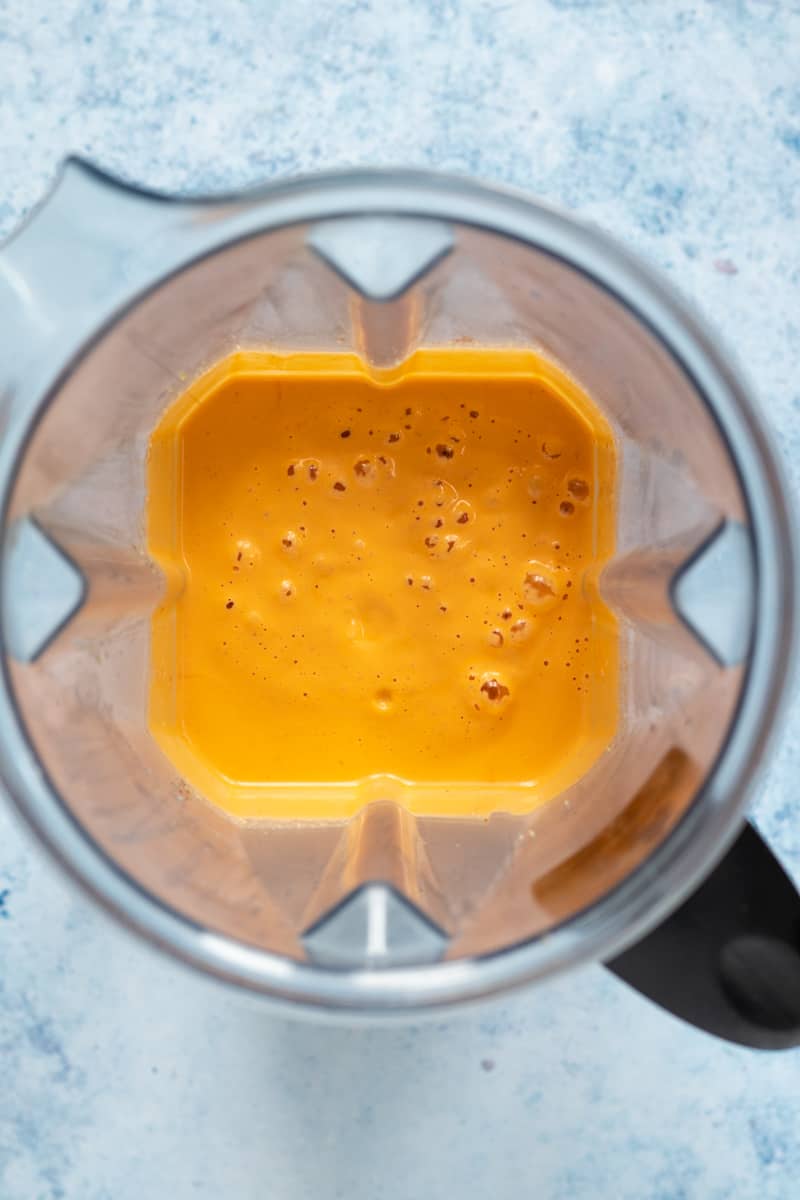 looking inside blender full of smooth pimento cheese sauce.