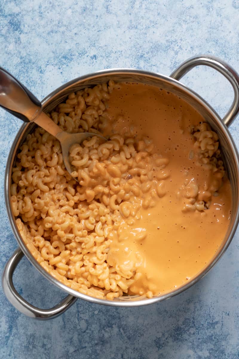 a view inside the pot with cheesy sauce coating freshly cooked macaroni.