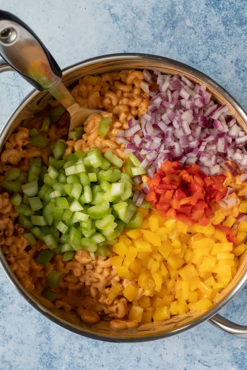 adding chopped veggies to the pot.