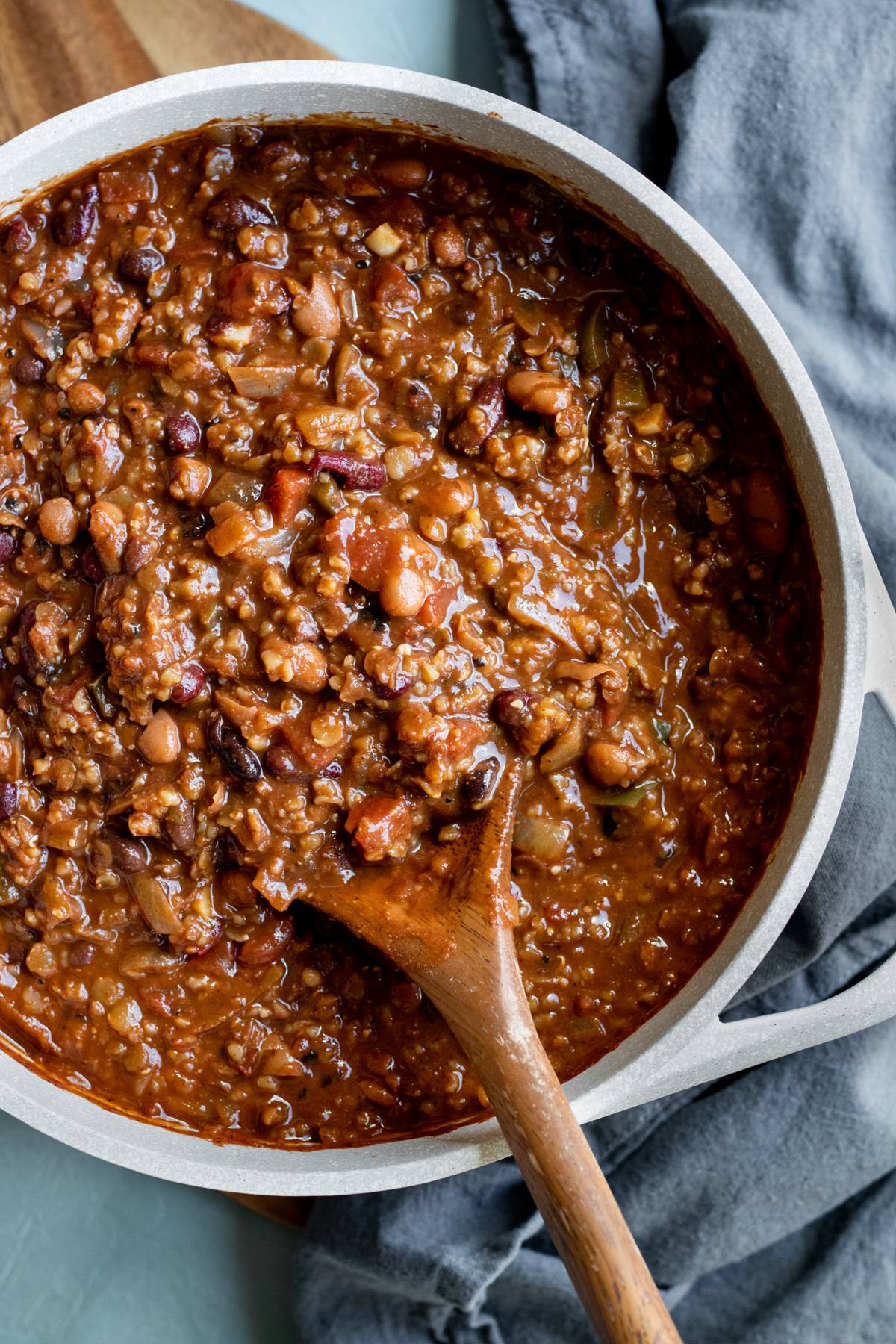 overhead view of hearty lentil chili in a pot.