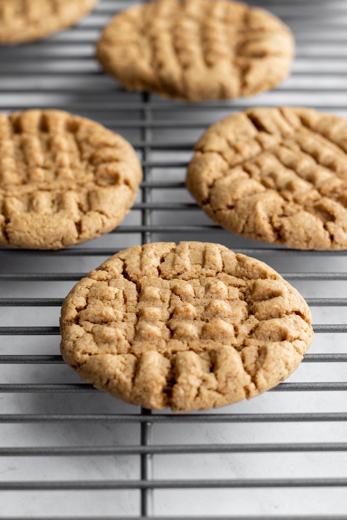 oil-free peanut butter cookies cooling on a rack.