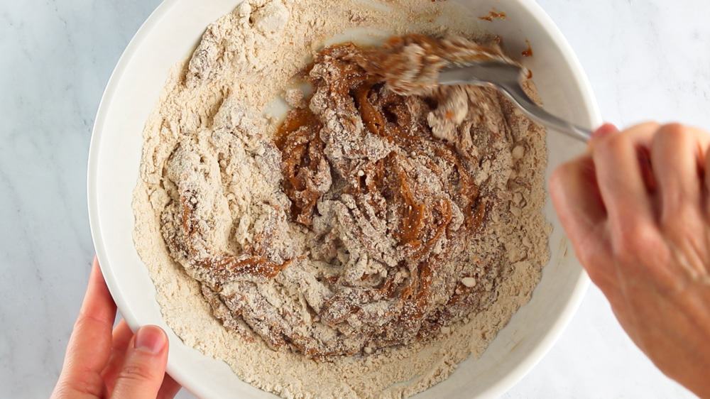 Stirring together the ingredients in a large mixing bowl.