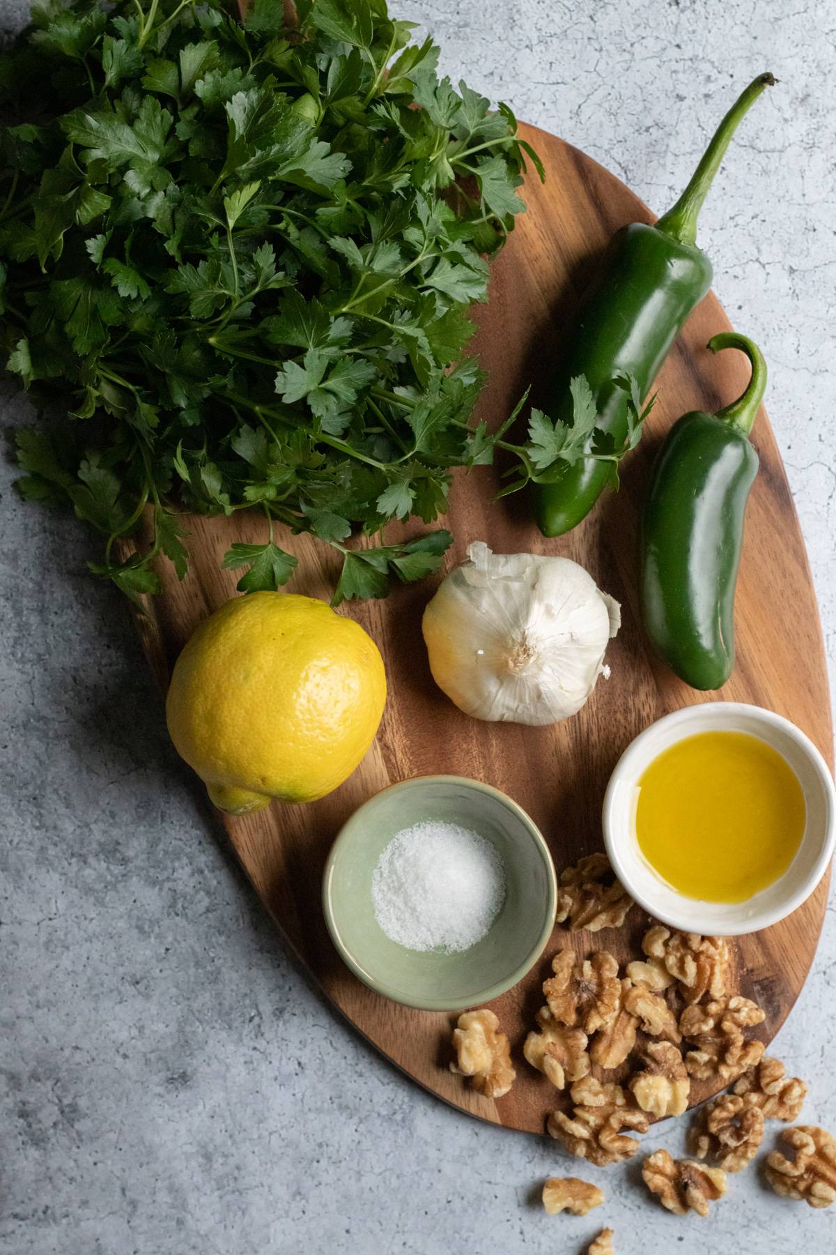 parsley pesto ingredients on a cutting board.