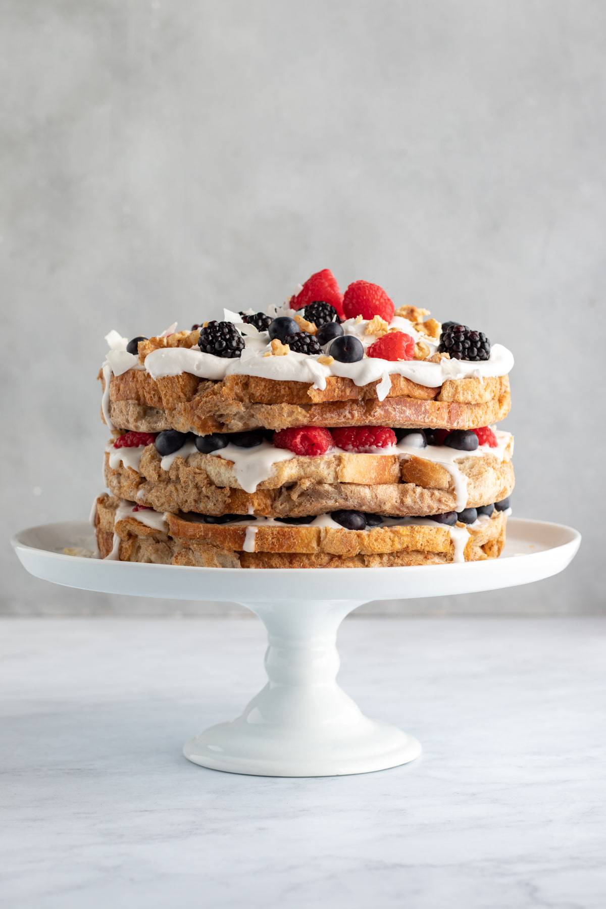 3-layer french toast cake on a white cake stand