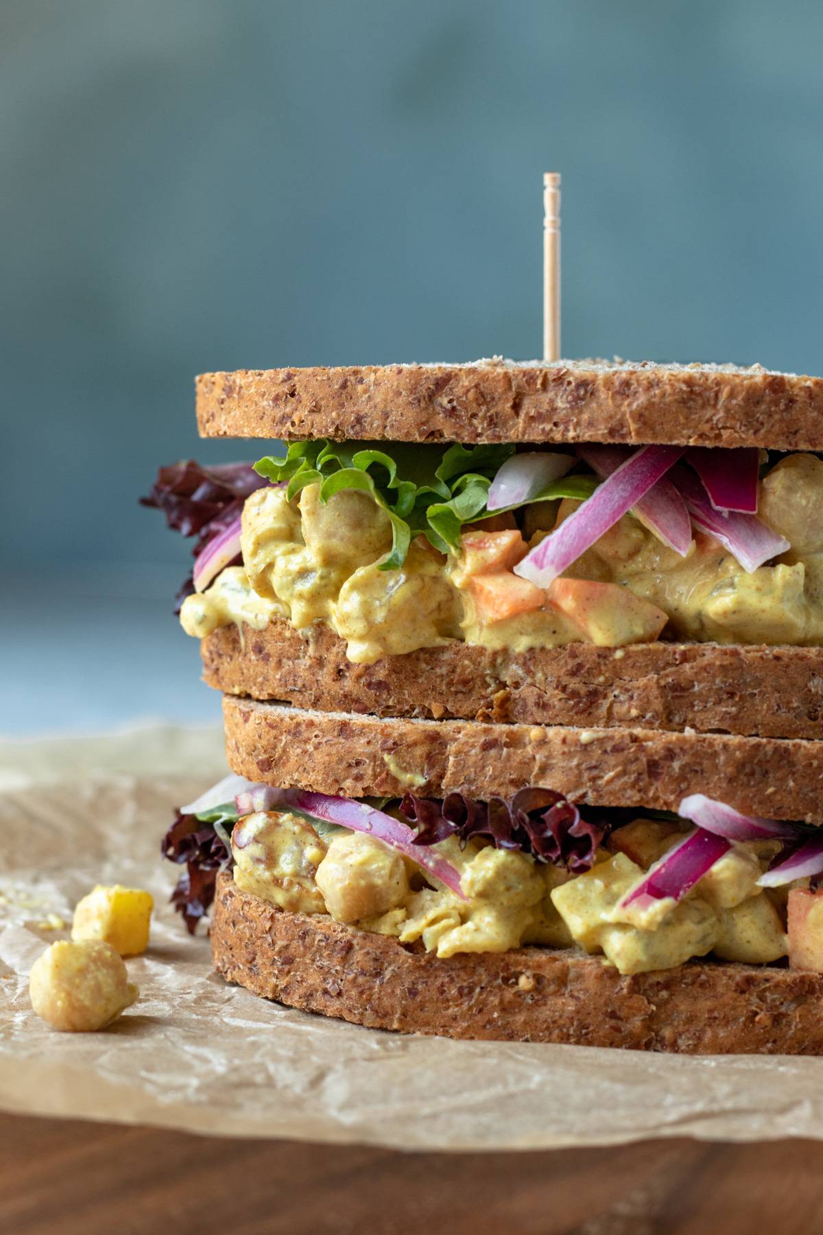 curried chickpea salad on whole-grain bread, two sandwiches stacked.