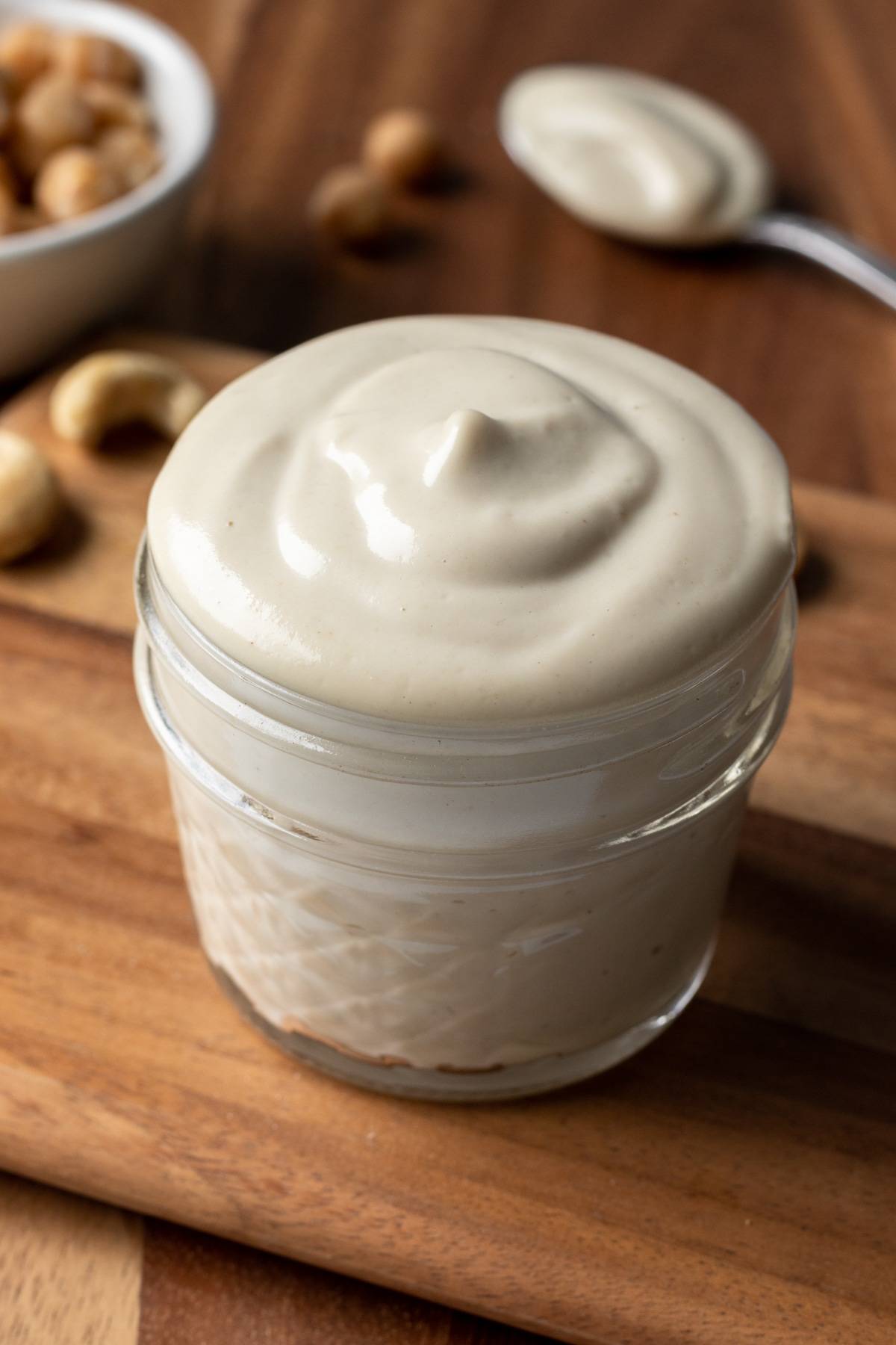 looking down at the top of the creamy mayo in a small jar.